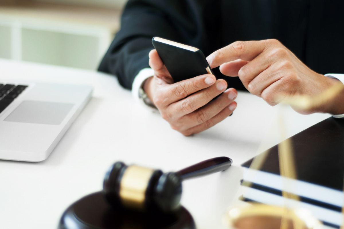 A man in a suit is using a cell phone for digital marketing.