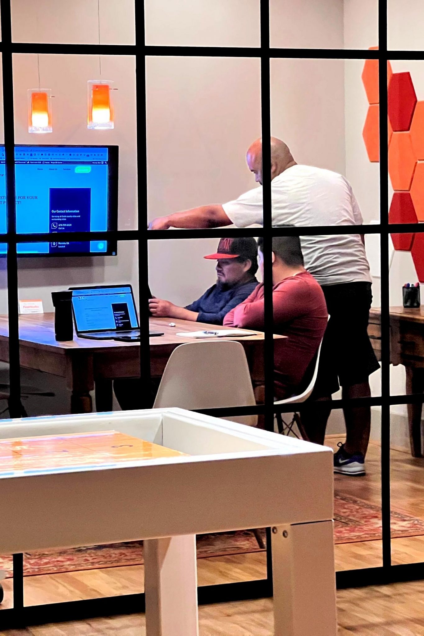 A technical seo company collaborating at a table in an office.