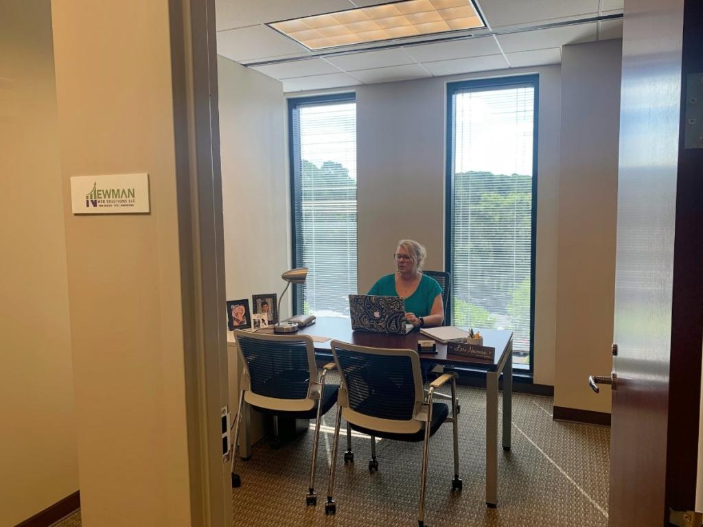 A woman sitting at a desk in an Atlanta office.