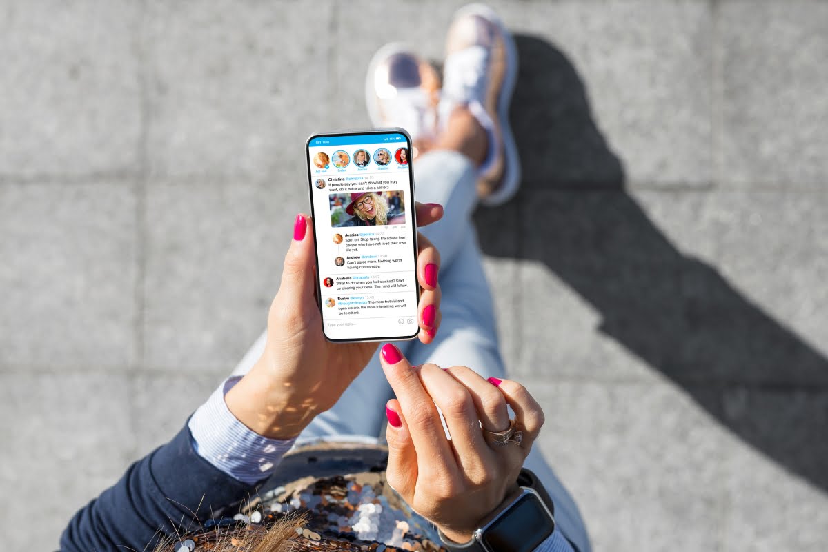 A woman holding a smartphone with shadow banning.