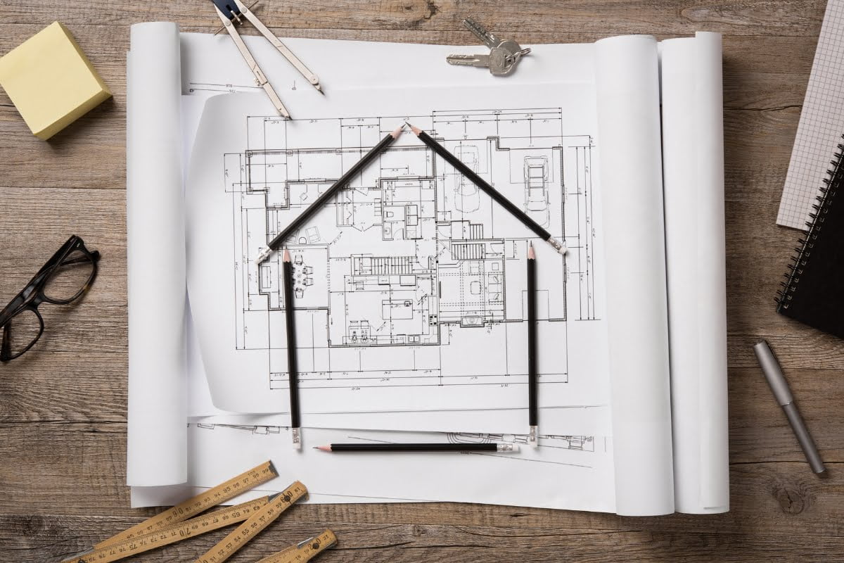 A drawing of a house on a piece of paper showcasing a construction marketing strategy.