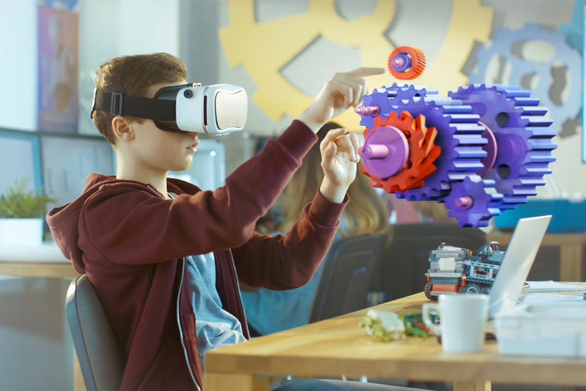 A boy is using a vr headset at his desk to experience a virtual reality construction marketing strategy.