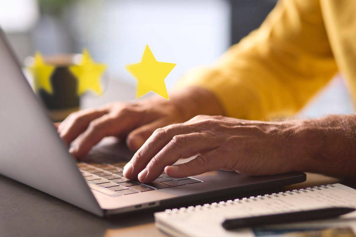 A man typing on a laptop to fix suspended business profiles.