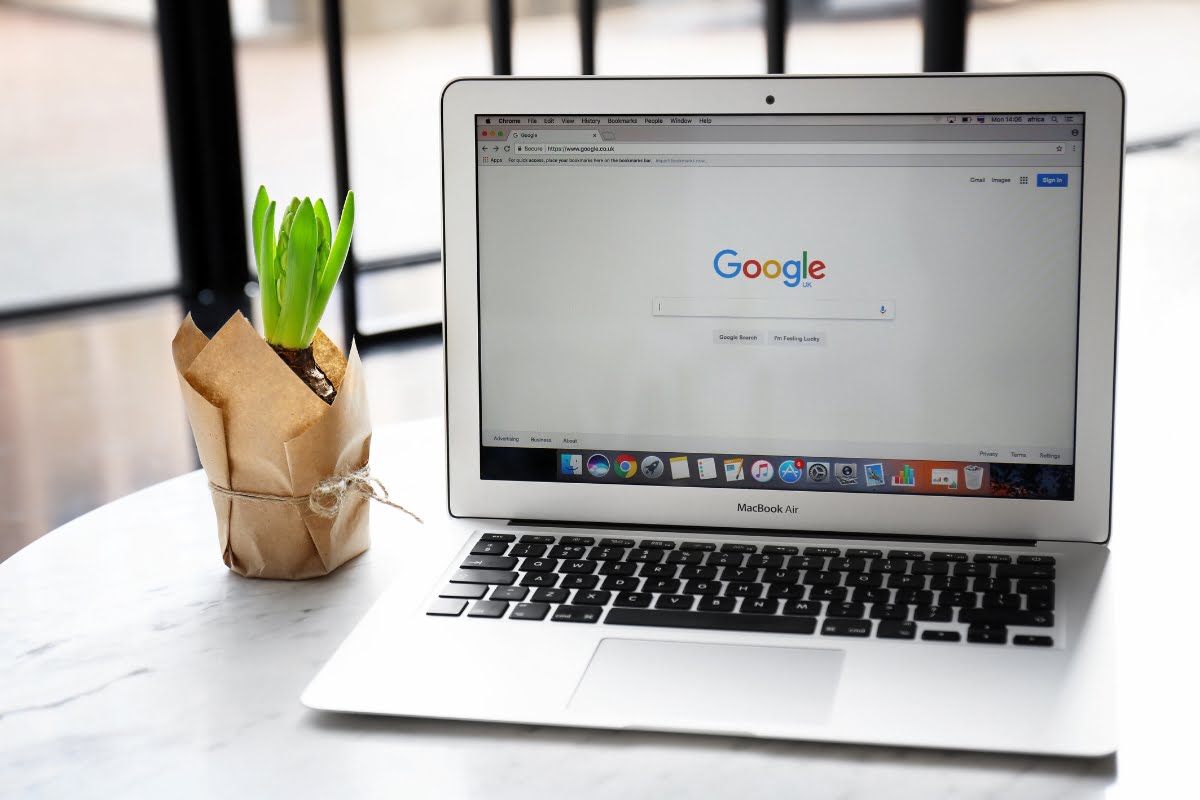 A laptop featuring a prominent Google search engine logo, placed on a table.