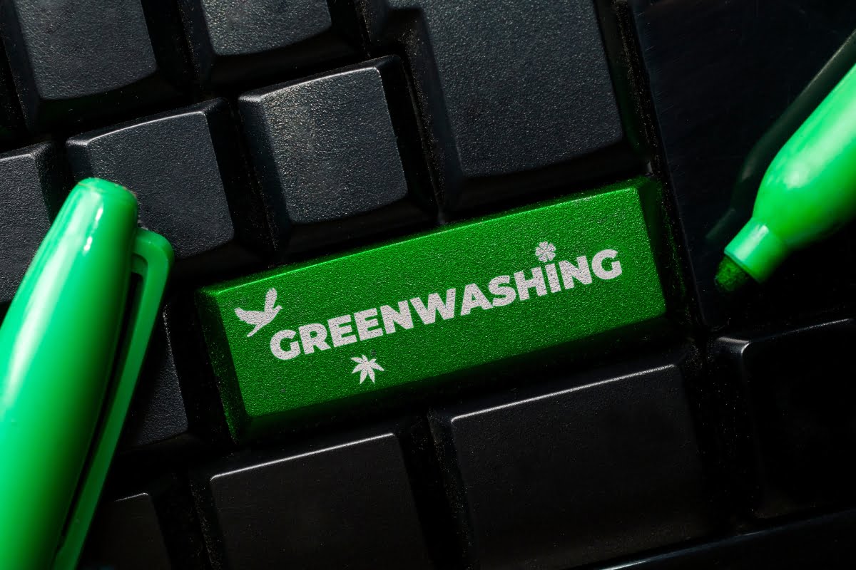 A keyboard button adorned with pens, emphasizing the importance of avoiding greenwashing.