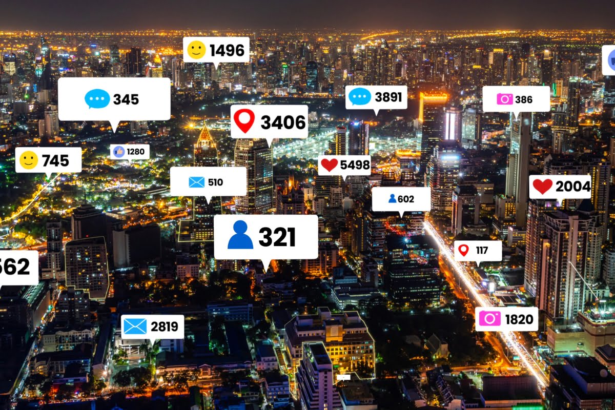 A city at night adorned with numerous social media icons, showcasing the thriving local store marketing scene.