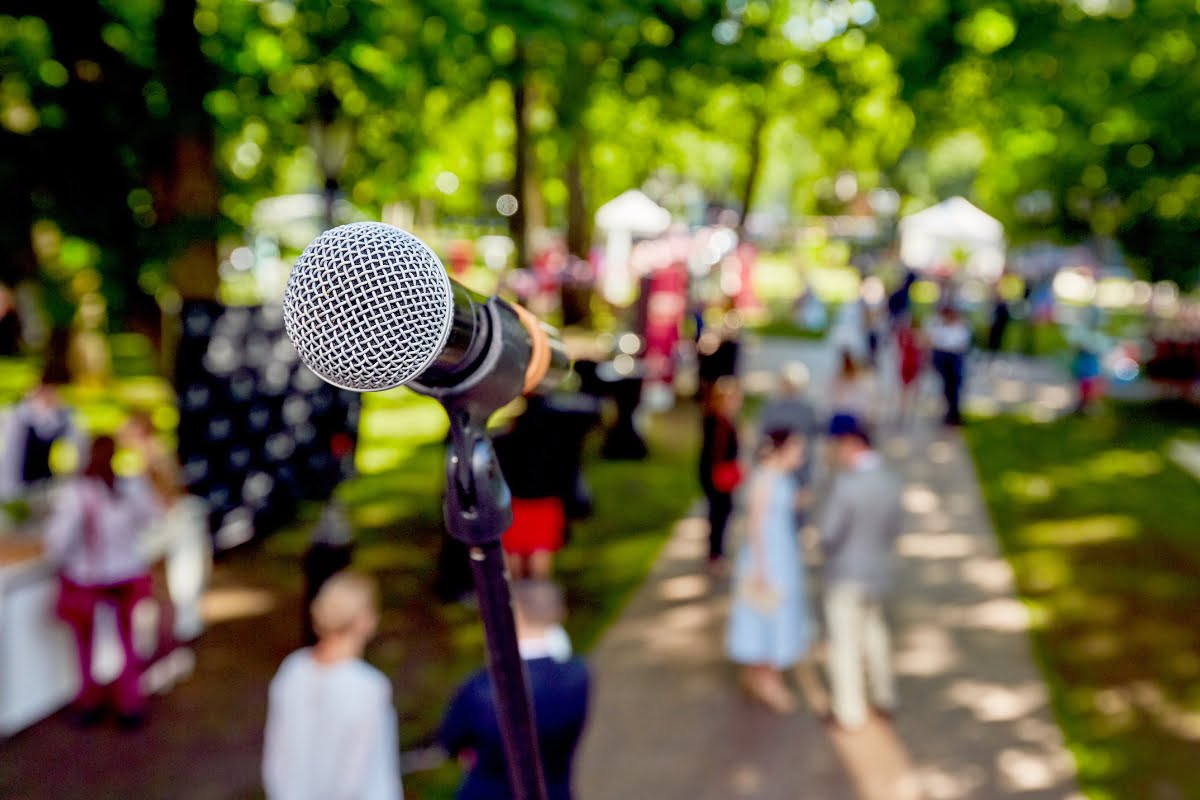 A microphone in a park with people in the background, showcasing local store marketing.