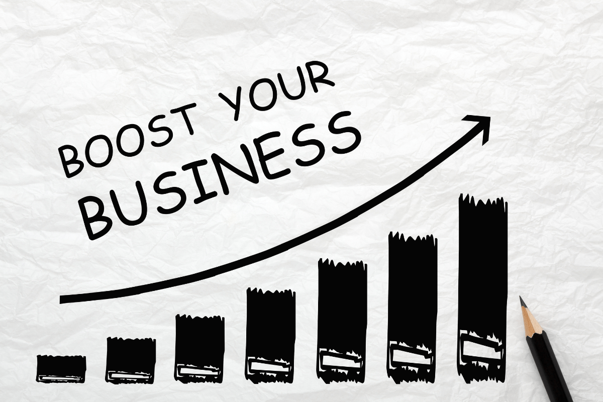 The phrase "boost your business" appears on a piece of paper, showcasing the result of utilizing exit intent popups.