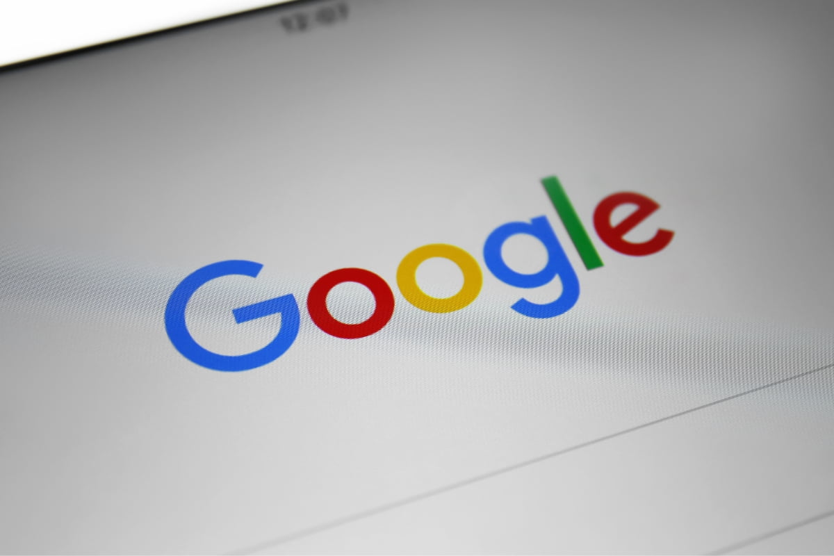 A close up of the google logo on a tablet, emphasizing its significance for first page ranking on Google.