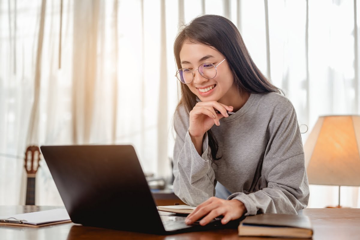 A young asian woman is using a laptop at home for her home improvement business.