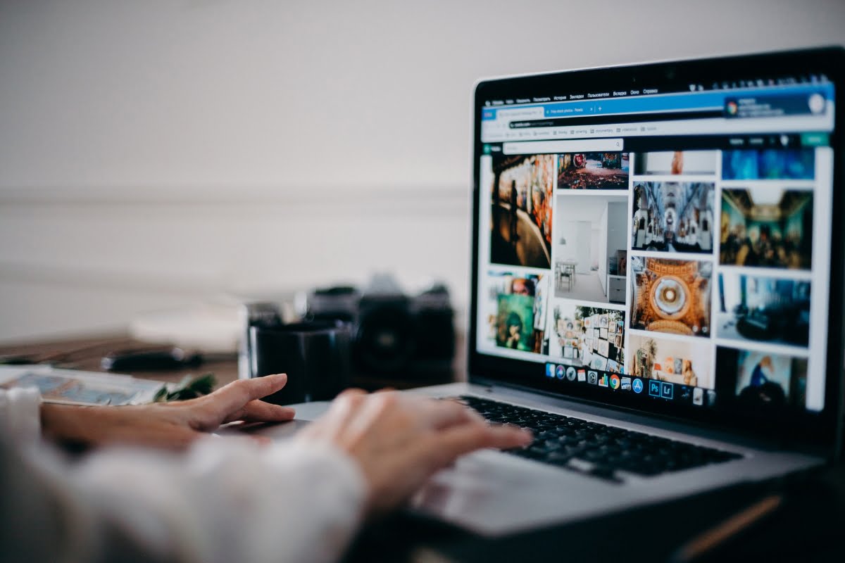 A person using a laptop to optimize images for web.