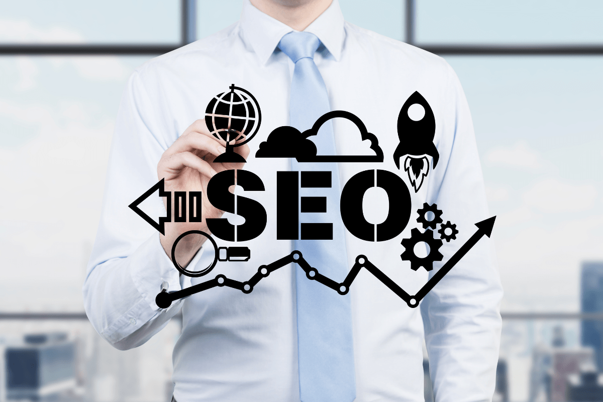 A businessman drawing the word SEO
as part of his marketing plan.