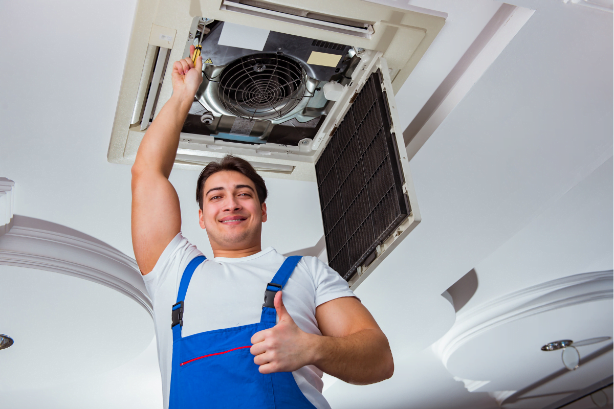 A man holding an air conditioner in his hands, showing a successful HVAC SEO marketing plan.