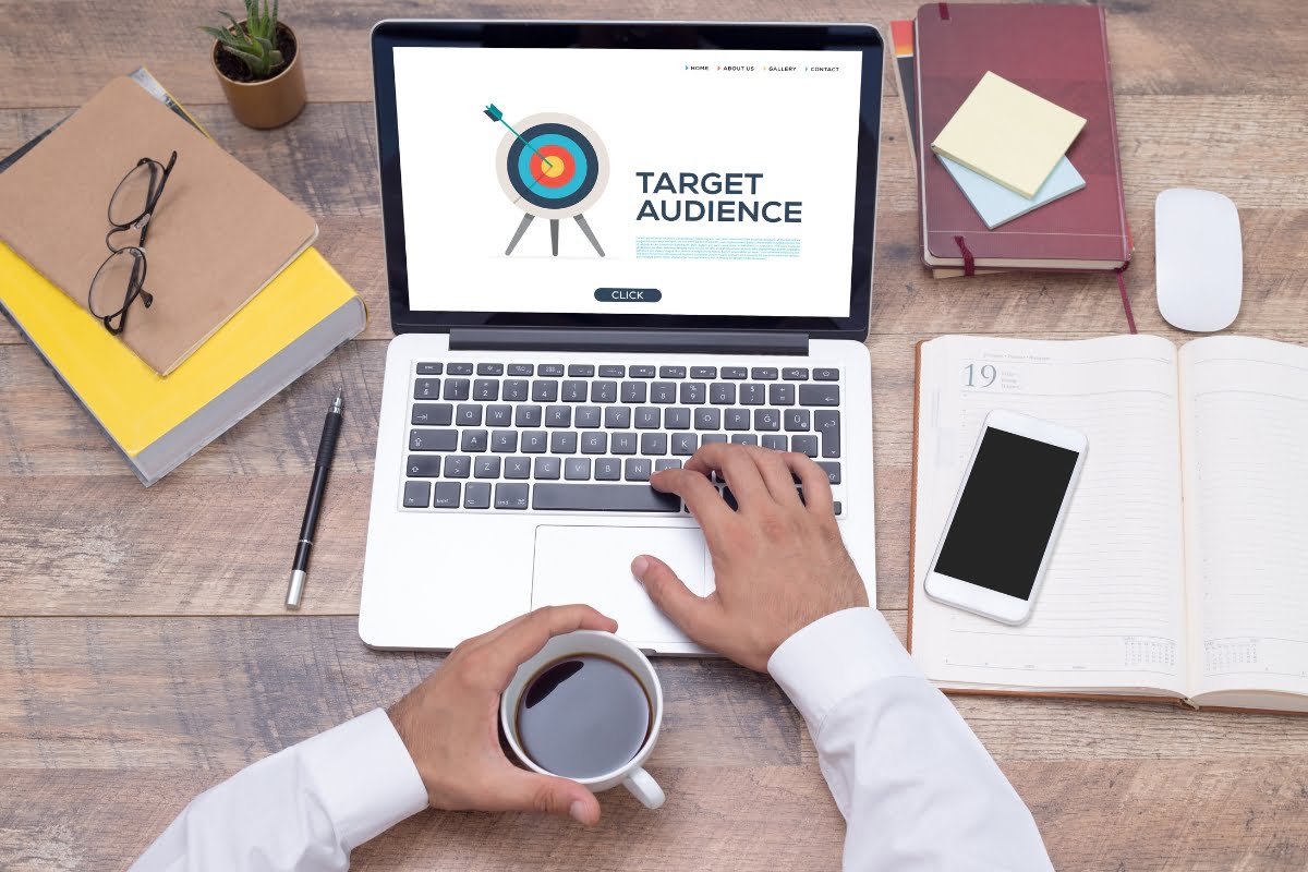 A man conducting keyword research on a laptop displaying the word target insurance.