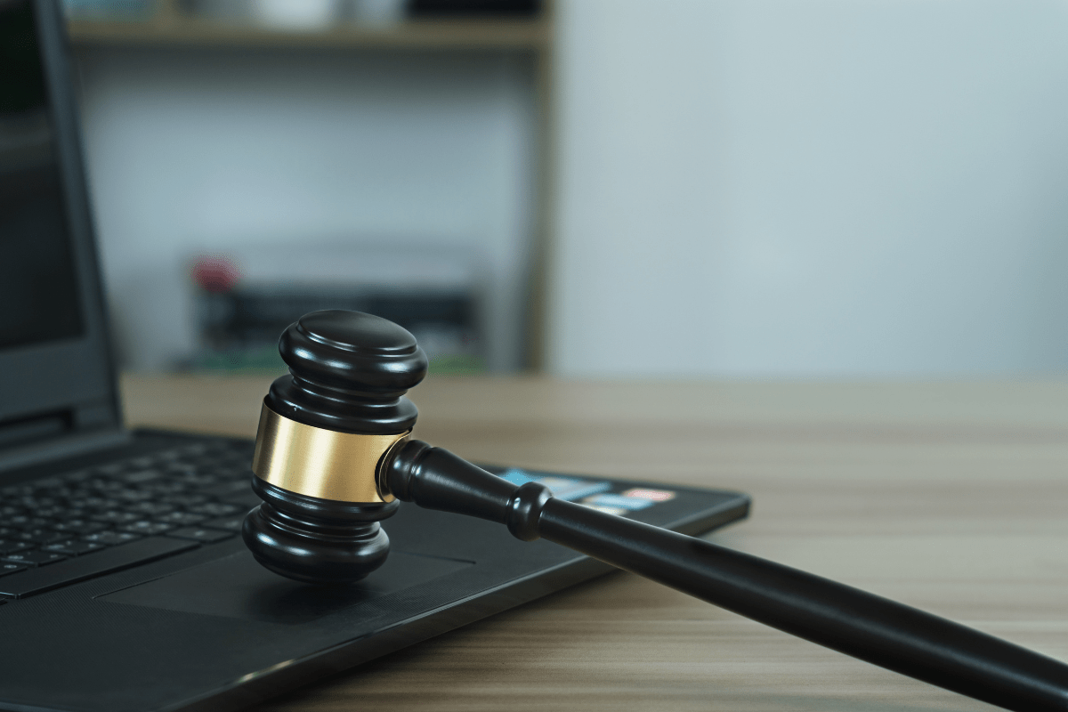 A gavel sits on top of a laptop computer, perfectly illustrating the professionalism and expertise expected in law firm website design.