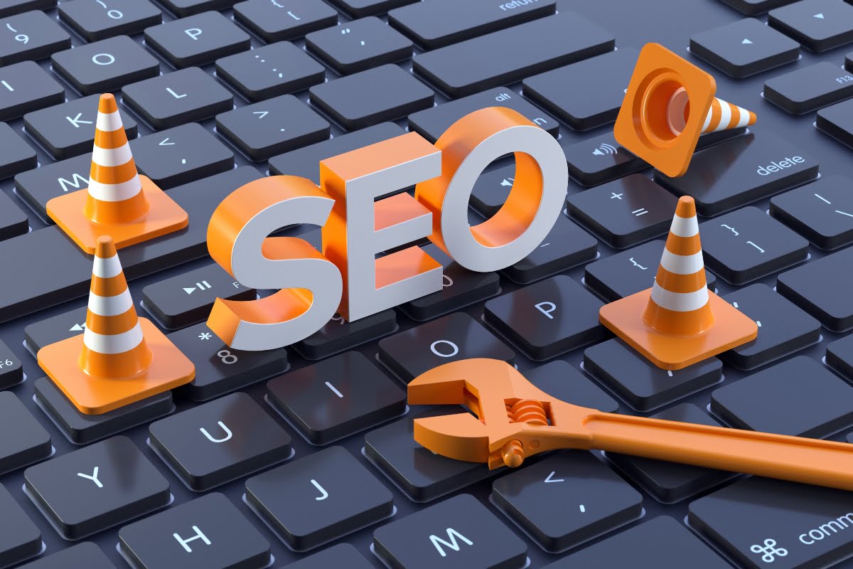 The word seo is surrounded by orange cones on a keyboard.