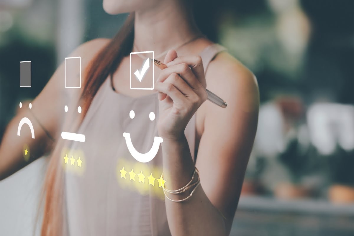 A woman is engaging in spa marketing by drawing a smiley face on a whiteboard.