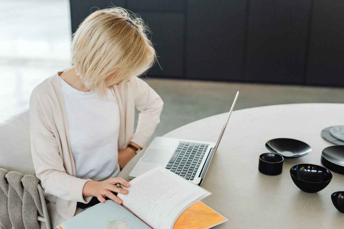 A woman working on a laptop to build a WordPress website with CMS functionalities.