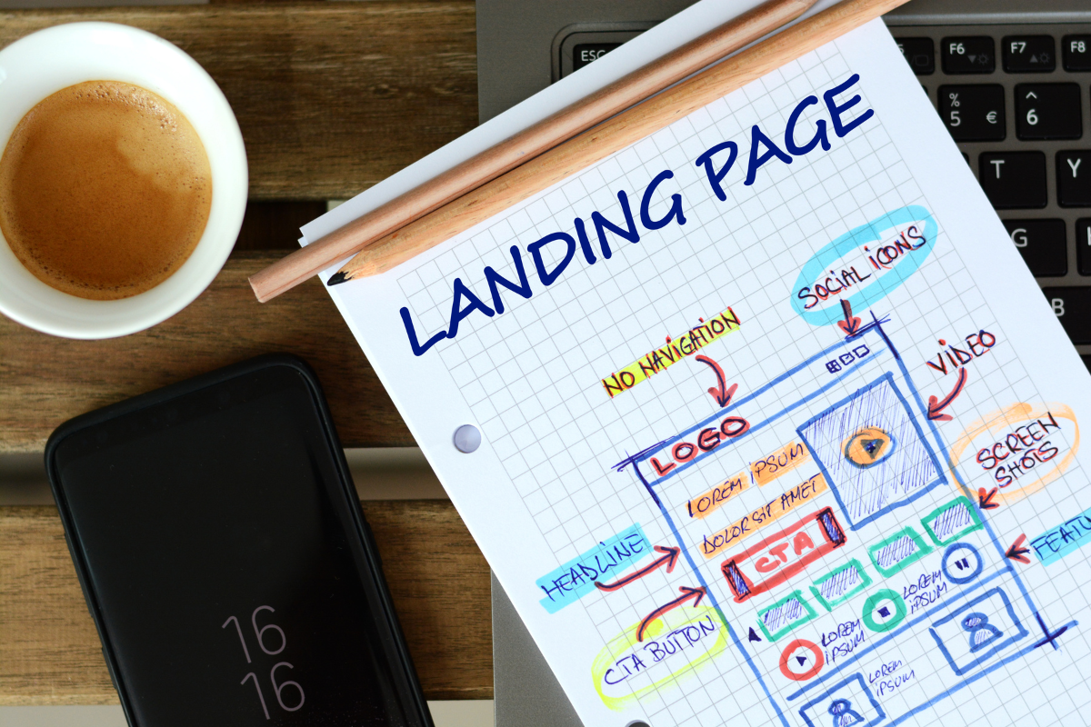 This notebook with the word "landing page" next to a cup of coffee is designed to boost search visibility.