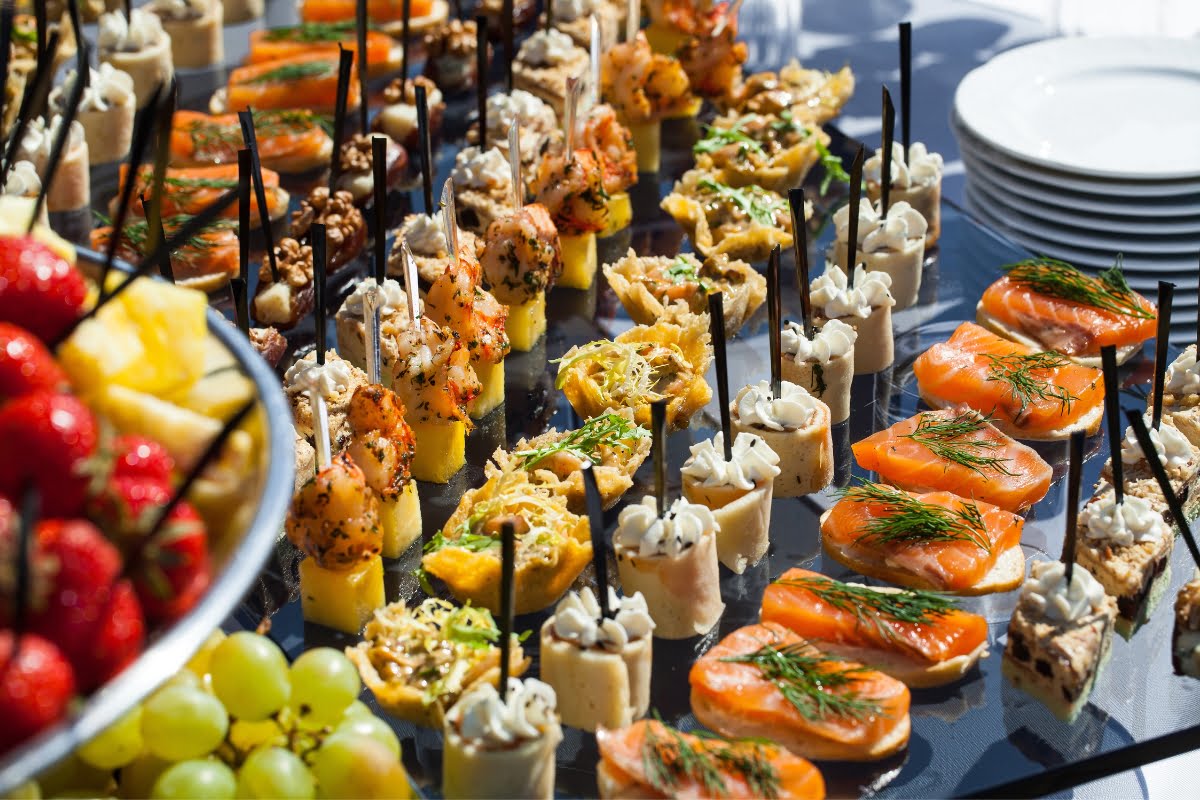 A variety of appetizers are on display for catering clients at a party.