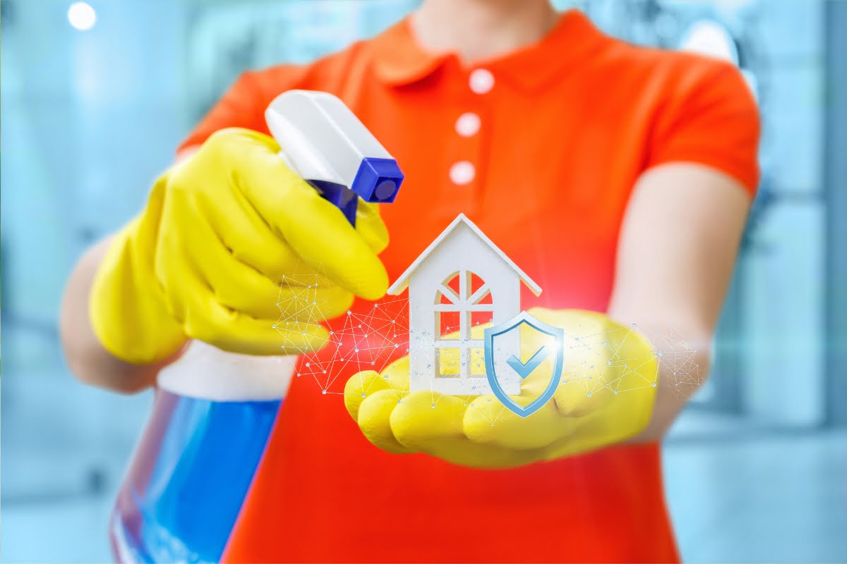 A woman holding a spray bottle with a house on it, showcasing innovative cleaning advertising ideas.