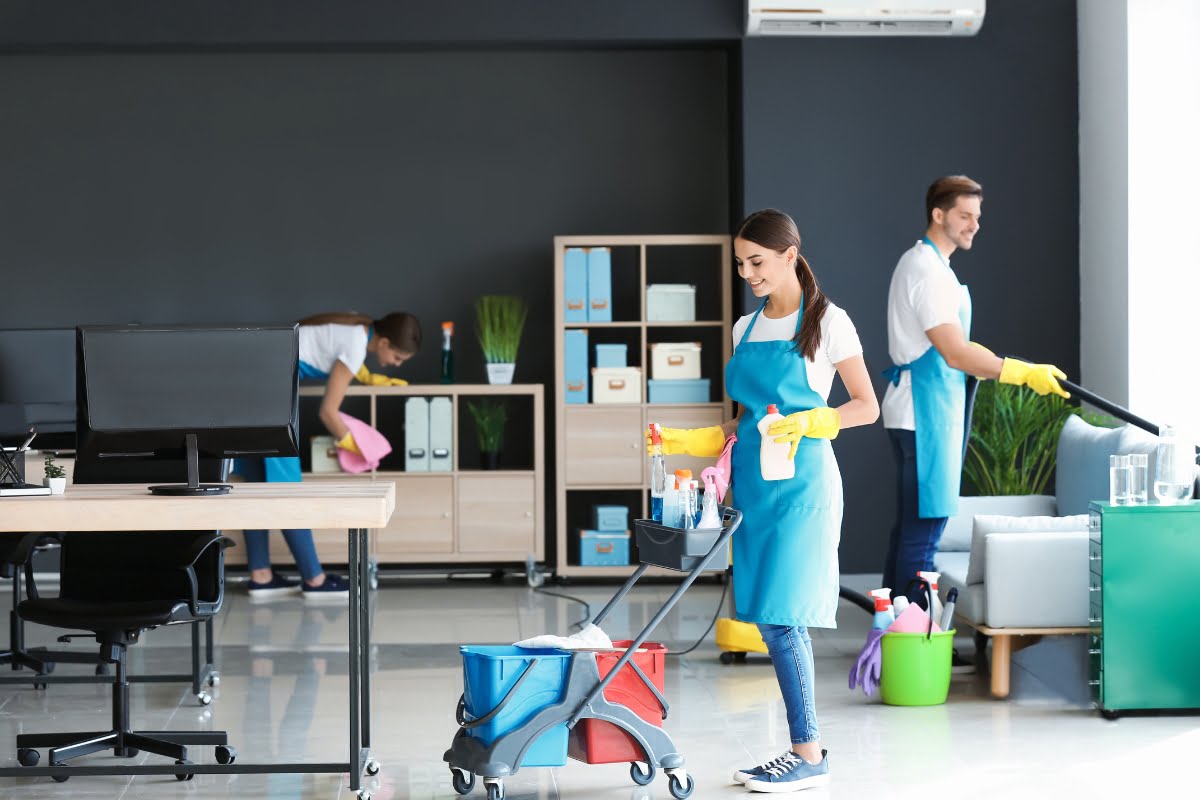 A group of people cleaning an office using advertising ideas.