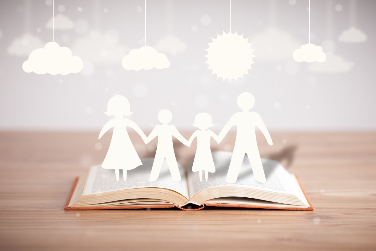 An open book showcasing a content marketing strategy with paper cut outs of a family.