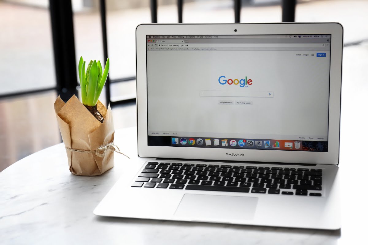 A laptop with Google Trends open on it sitting on a table.