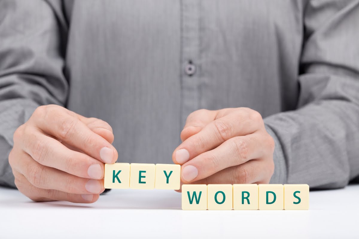 A man's hands displaying keyword clustering.