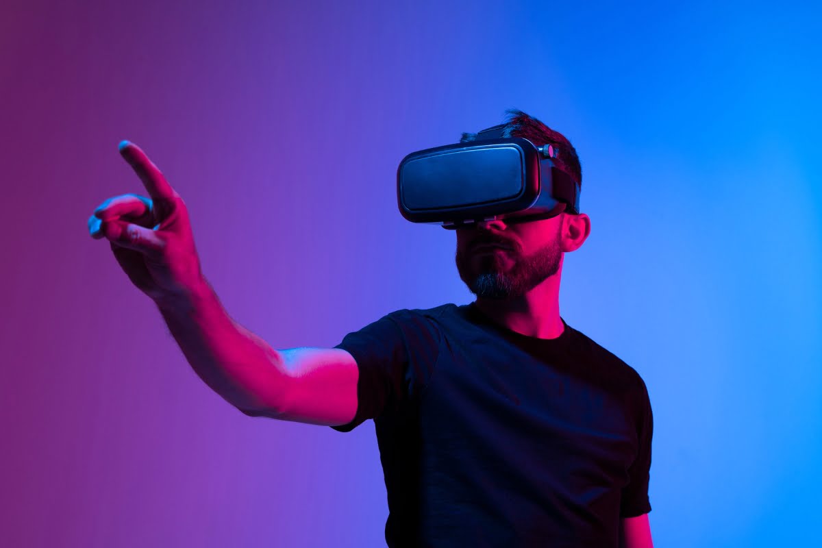 A man immersed in a metaverse, wearing a VR headset, enthusiastically pointing at something while engaging in immersive marketing.
