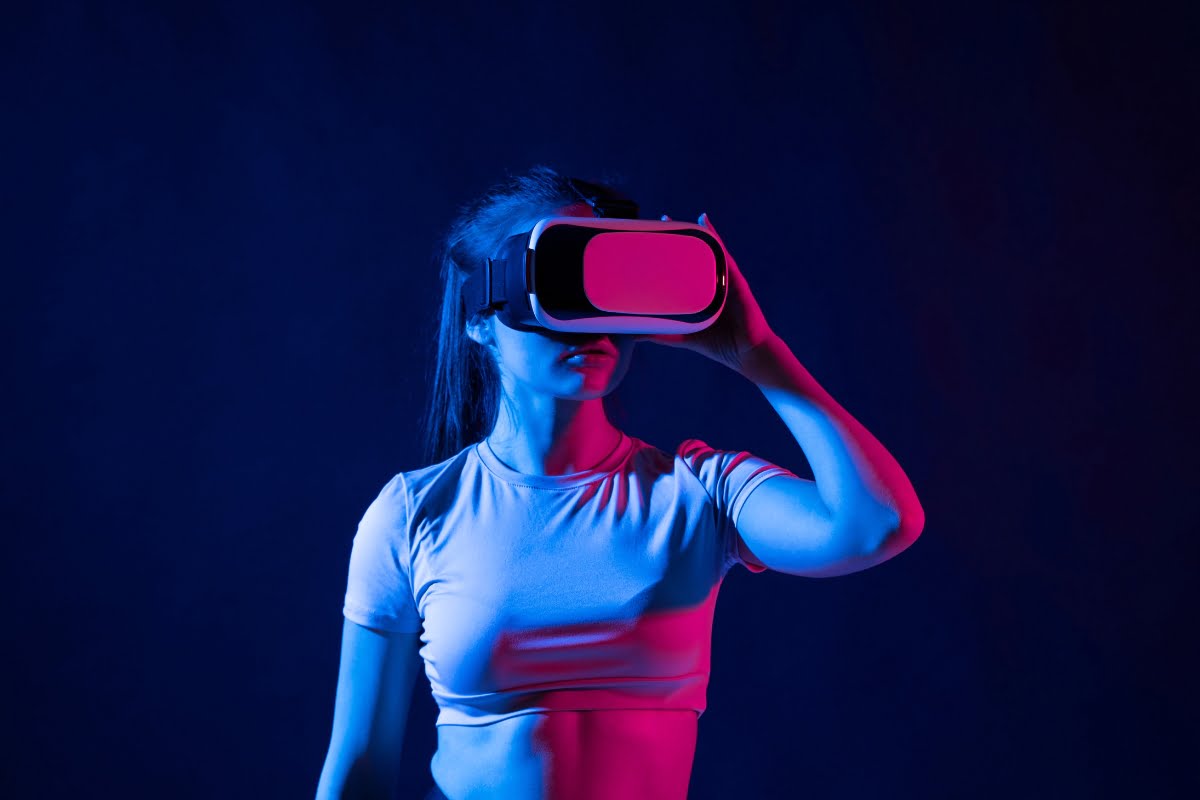 A woman engaging in metaverse marketing, wearing a vr headset on a blue background.