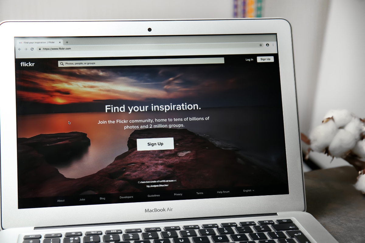 A laptop is displaying a one page website with the words find your inspiration.