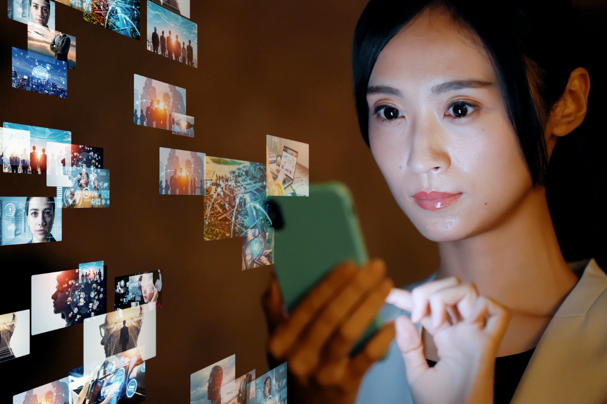 A woman is browsing through videos on her cell phone.