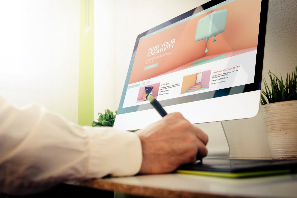 A man is working on a computer screen with a pen, editing WebP images.