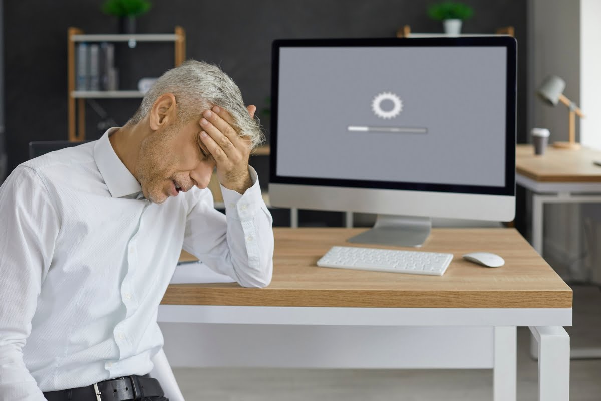 A man is conducting a website audit, sitting in front of a computer screen.