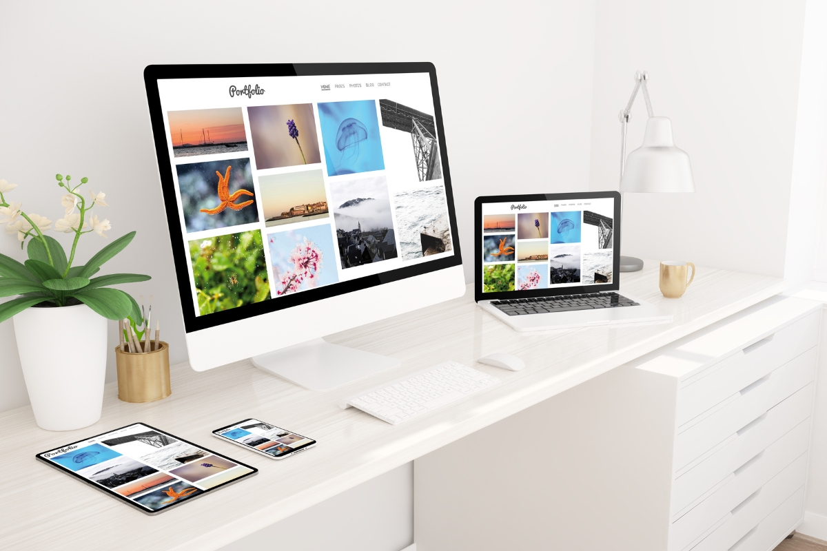         A computer and laptop on a desk for website photos.