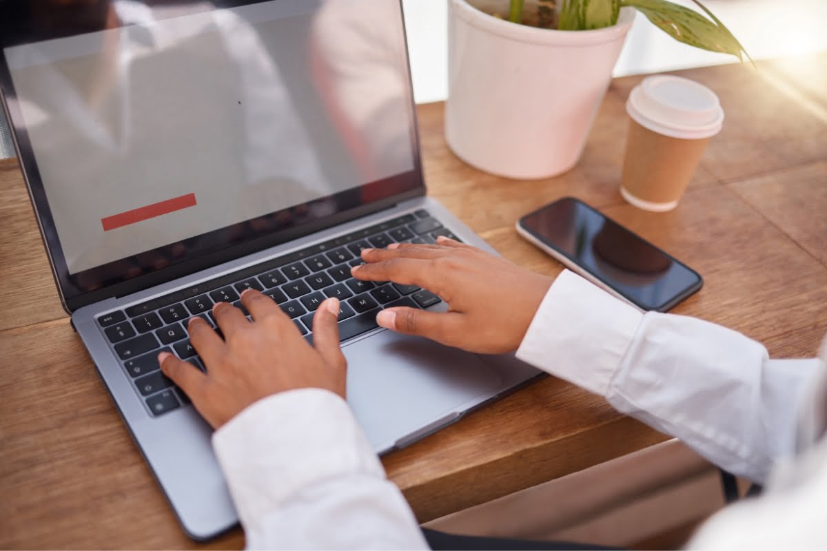 A woman updating a website on a laptop computer.