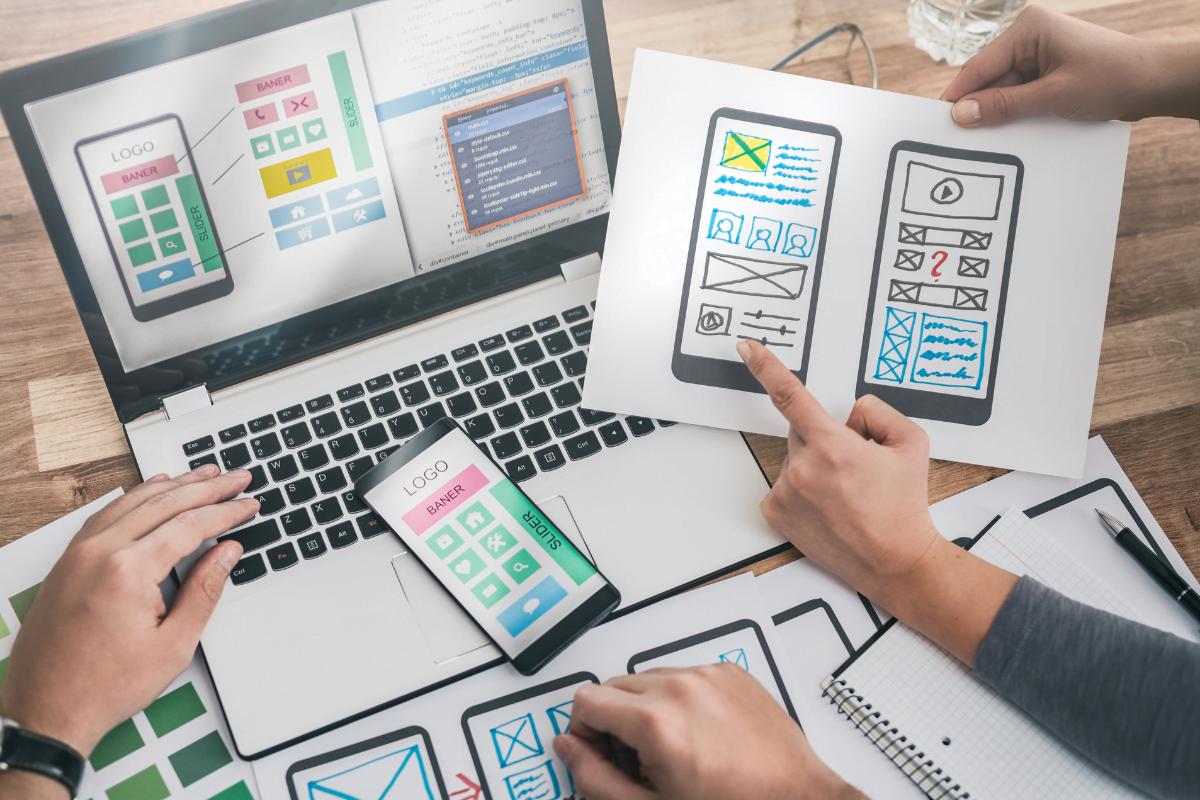 A group of people working on a WordPress website, using a laptop and a smartphone.