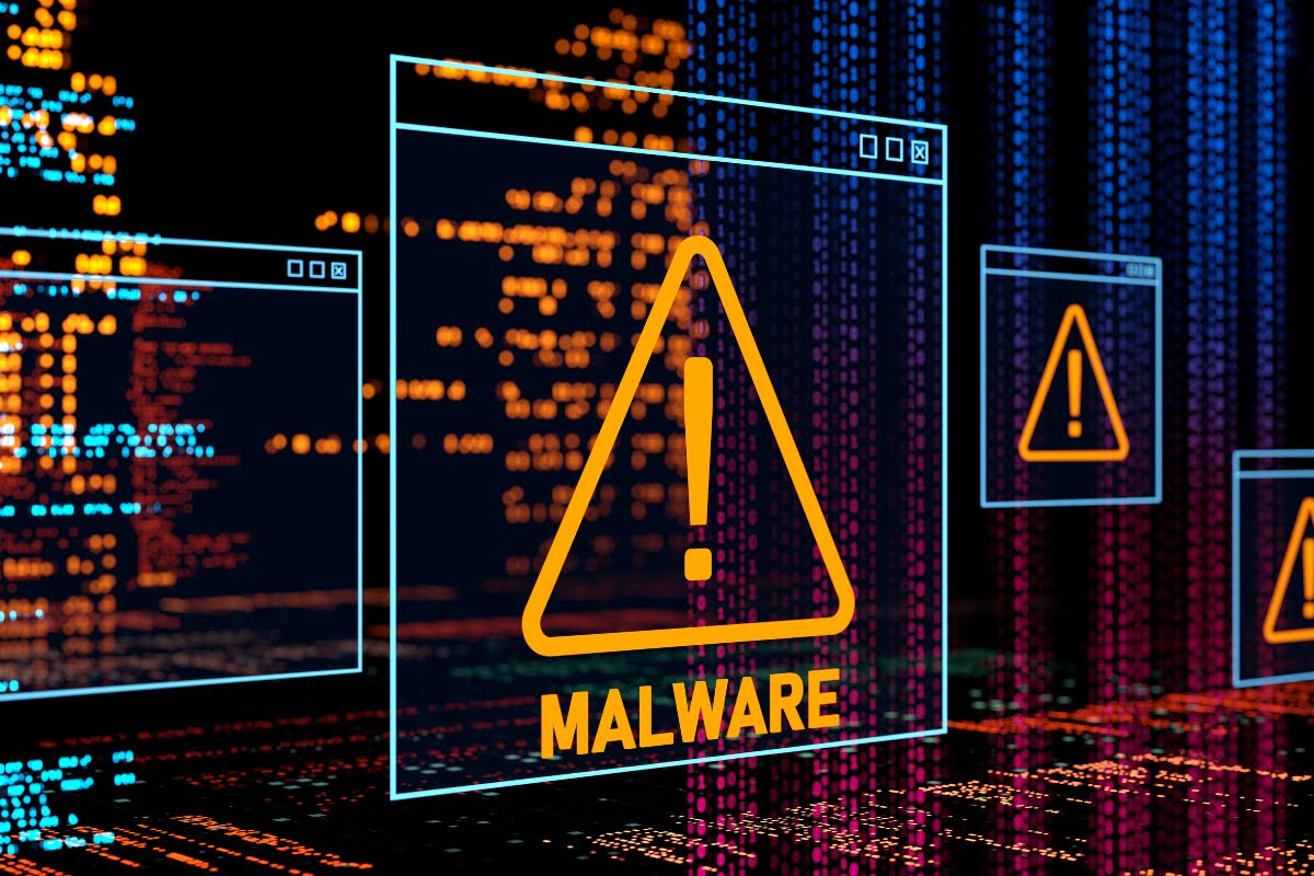 Enhance your WordPress security with a computer screen displaying a prominent warning sign for malware.