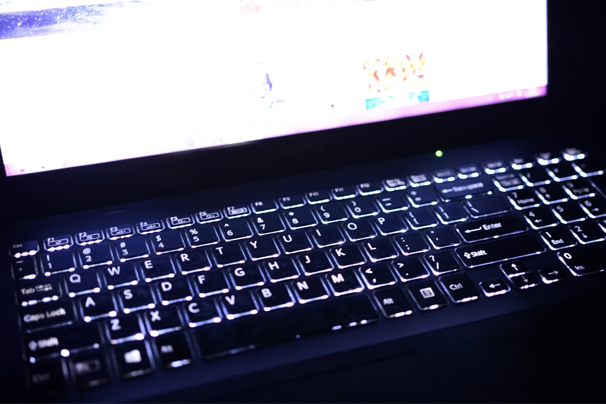 A close up of a laptop keyboard in the dark, perfect for those seeking help with WordPress.