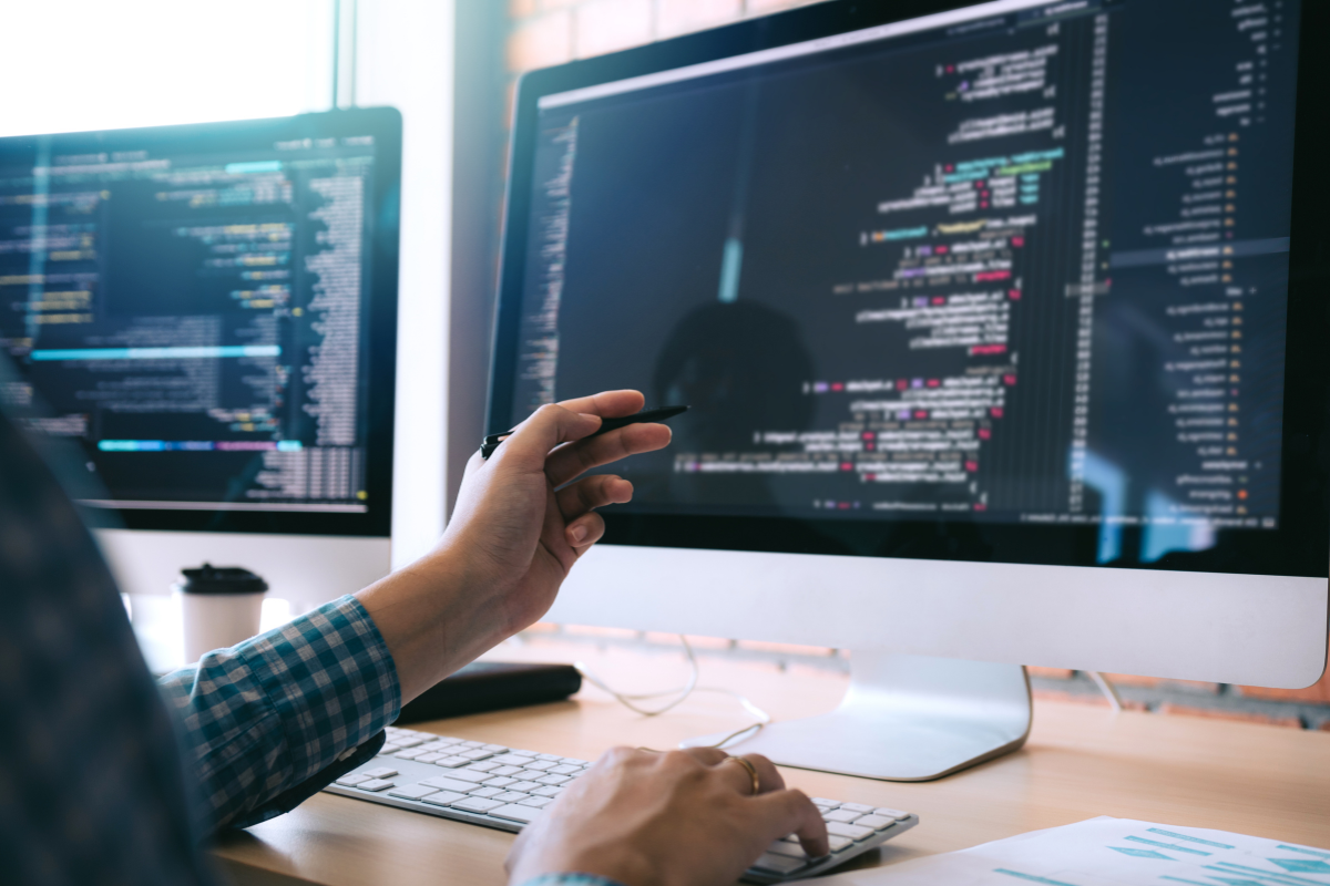 A man is coding on a computer.