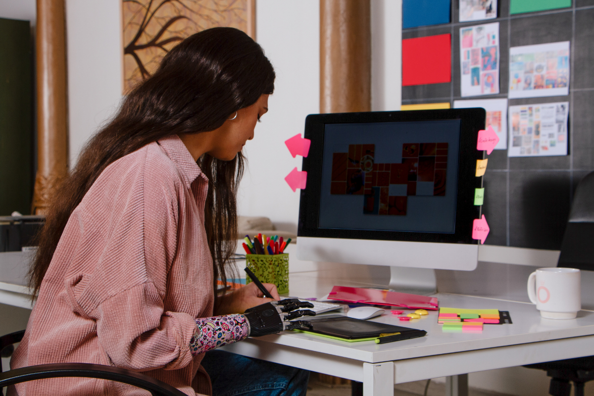 A woman sitting in a chair while doing some visual content for marketing purposes.