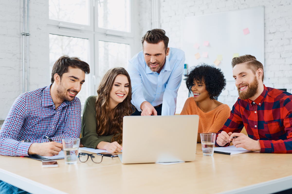 A group of people sitting around a table, discussing content marketing strategy.