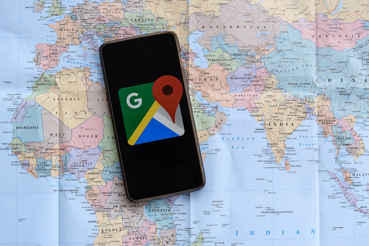 A smartphone with google maps on it displaying your business location on a world map.