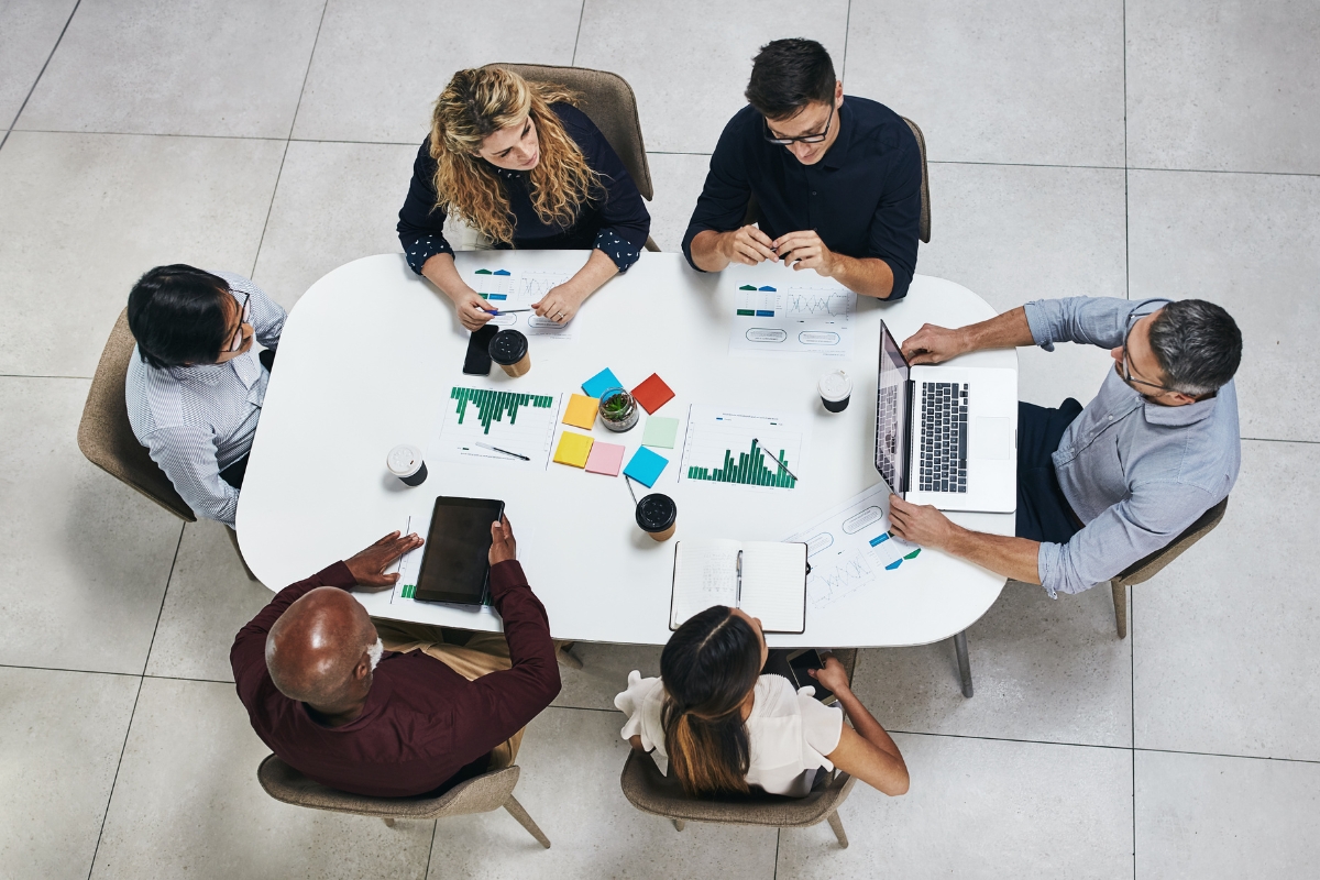 A group of people gathered at a table discussing marketing strategies.