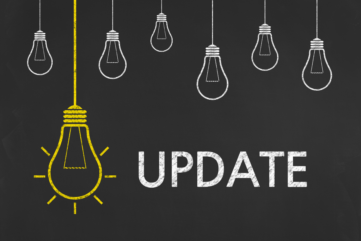 Light bulbs with the word "update" drawn on a blackboard, symbolizing the importance of staying current in a fast-paced world.