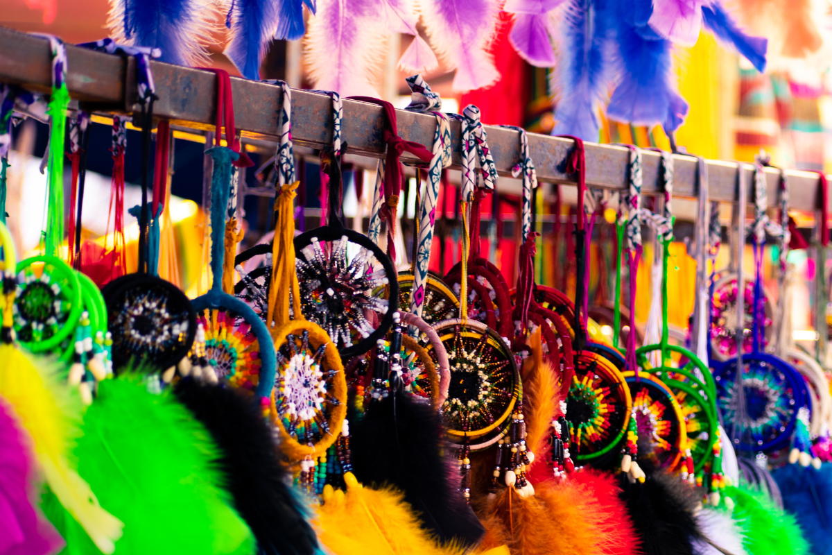 Colorful feathers hanging from a wooden rack, demonstrating the power of color psychology in marketing.