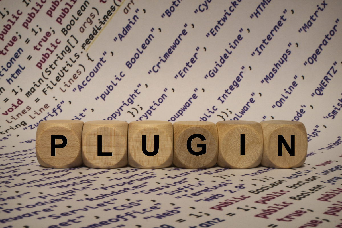 Wooden blocks with the word plugin on top of a paper.