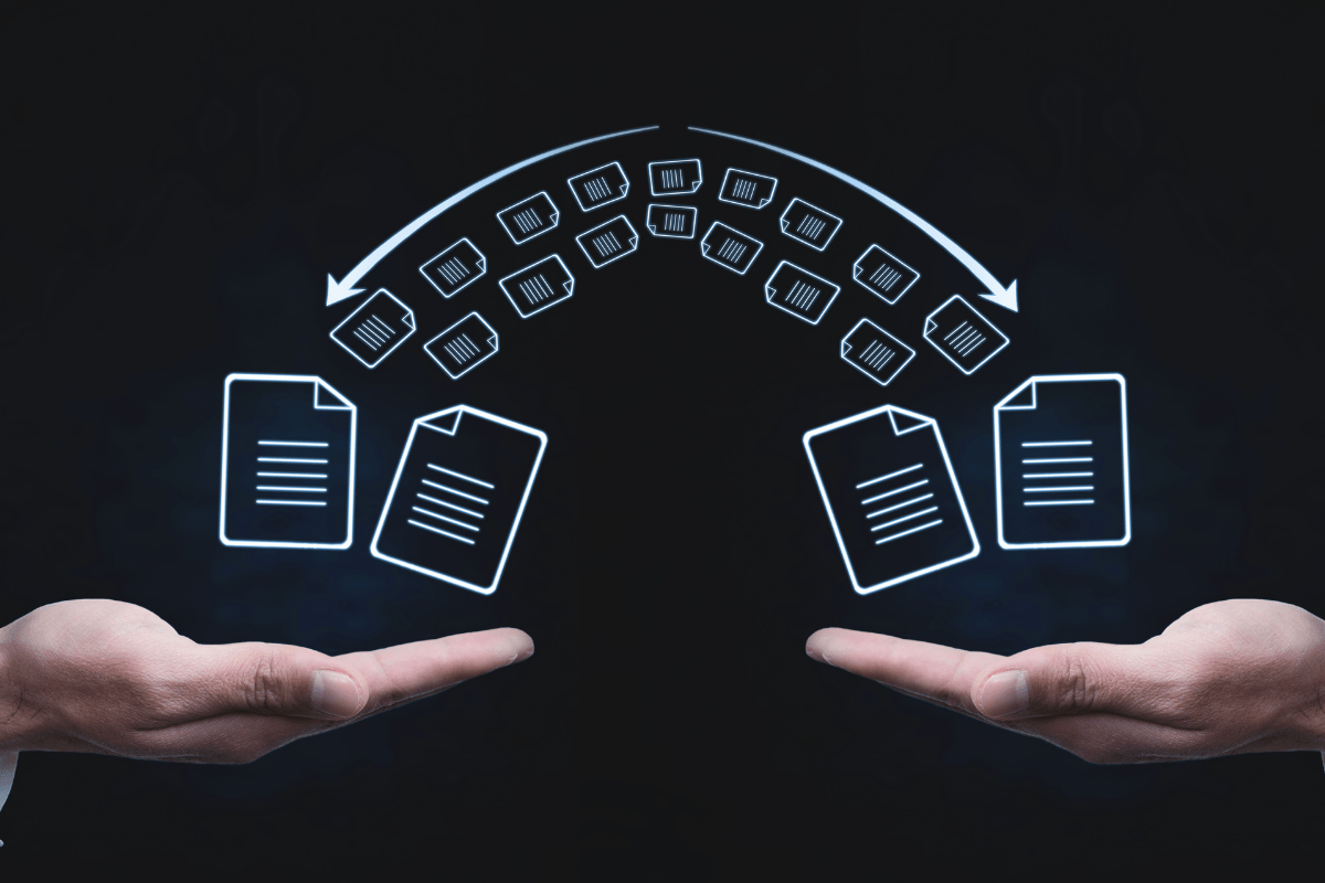 Two hands with files being transferred from one another as a sign of a website migration checklist.