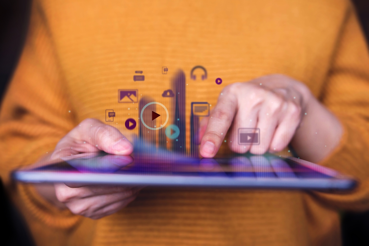 A woman is holding a tablet with social media icons on it, wondering about the purpose of a website.